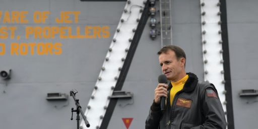 Capt. Brett Crozier, then-commanding officer of the aircraft carrier USS Theodore Roosevelt (CVN-71), addresses the crew during an all-hands call on the ship’s flight deck on Nov. 15, 2019. US Navy Photo