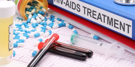 A picture of a file with hiv aids treatment written on the spine together with capsules, blood samples, syringe and an ECG chart.
