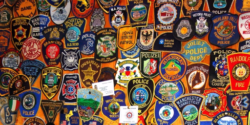 Shown is a portion of a wall that is covered with policemen's patches donated by visitors from all over the world, especially the USA & Europe.