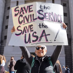 Independent public servants are a prerequisite for a functioning democracy. Photo from a protest outside the USAID HQ.