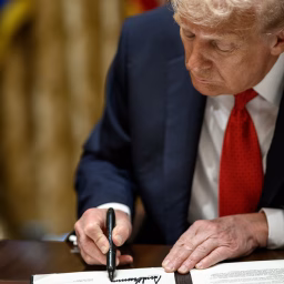 President Donald Trump signs a mineral agreement during a bilateral meeting with Australian Prime Minister Anthony Albanese in the Cabinet Room, Monday, October 20, 2025.
