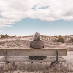 photo of landscape, sand, rock, person, woman, bench, old, alone, monument, looking, female, sitting, grandma, grandmother, relaxing, outdoors, sculpture, geology, temple, ruins, badlands, age, senior, elderly, granny, adult, retired, mature, ancient history, setee