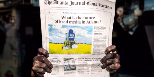 An employee with ink-stained hands poses with a final print edition of The Atlanta Journal-Constitution at the printing press at Metro Market Media in Gainesville on Tuesday, Dec. 30, 2025. It was the final print run for The Atlanta Journal-Constitution, after 157 years.